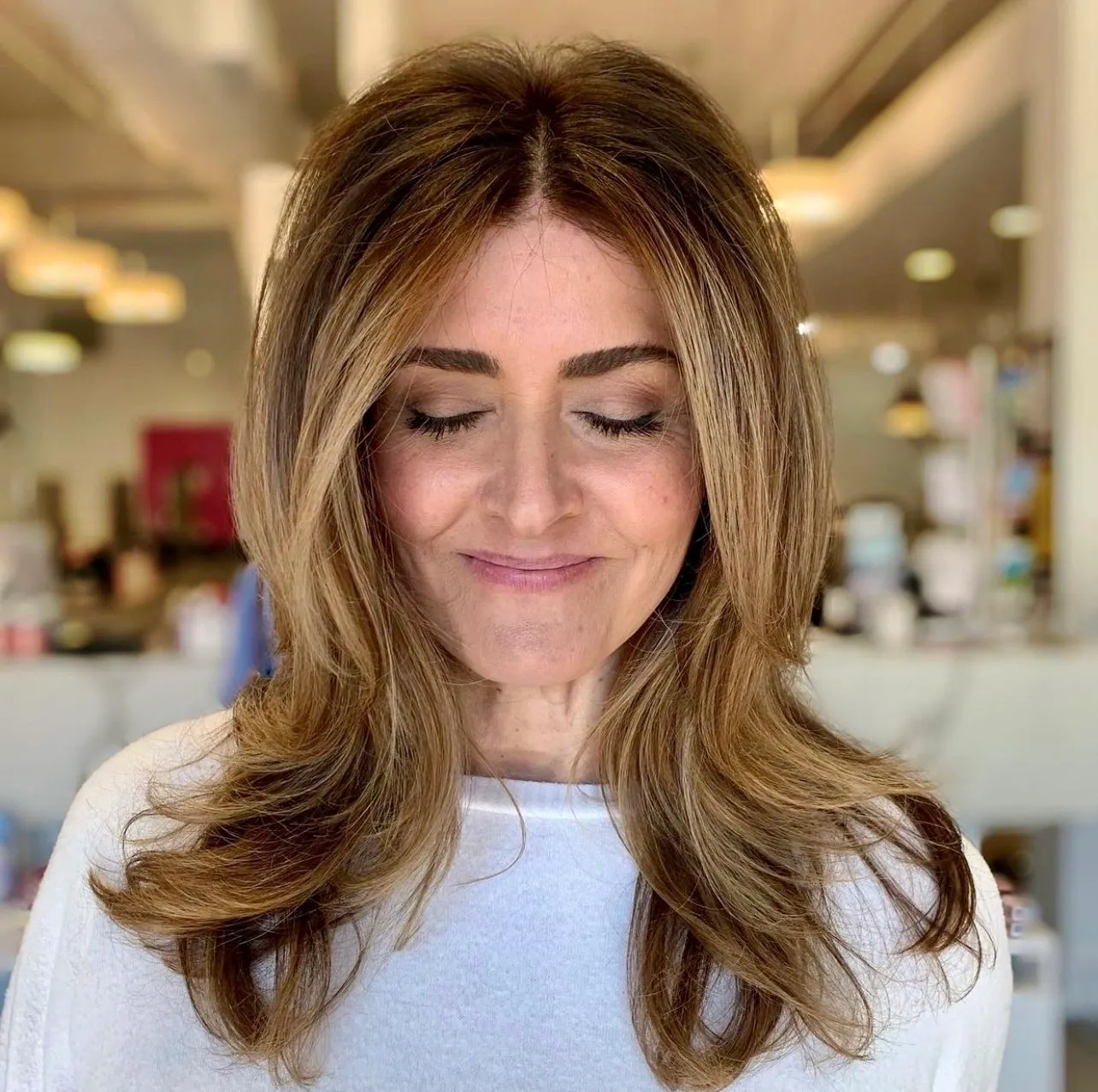 A woman with long hair and a white shirt