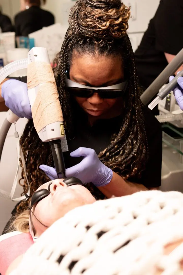 A woman is getting her teeth cleaned by an esthetician.