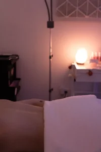 A bed room with a lamp and a candle