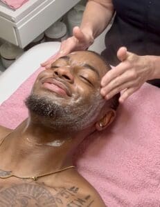 A man getting his face washed with soap.