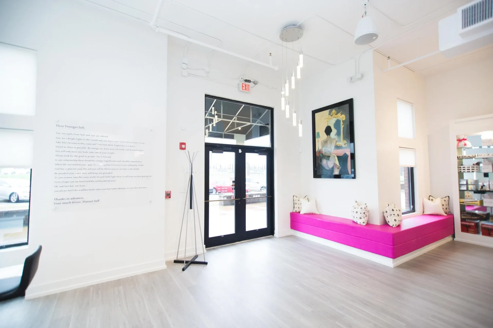 A room with a pink door and a large window.