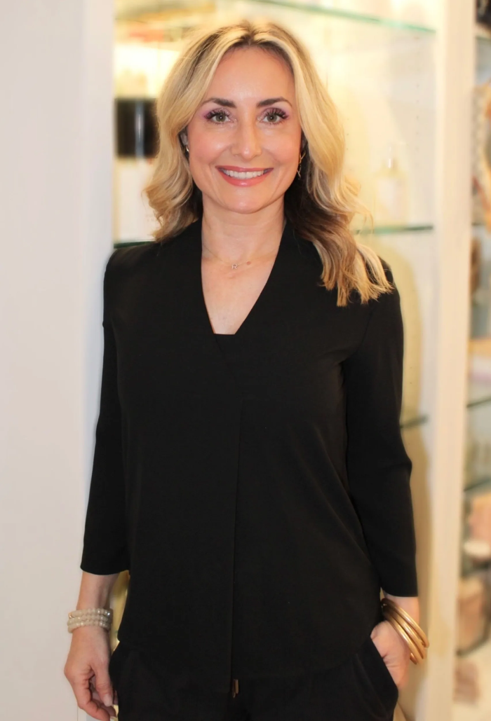 A woman in black shirt smiling for the camera.