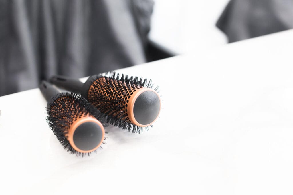 A pair of hair brushes sitting on top of a counter.