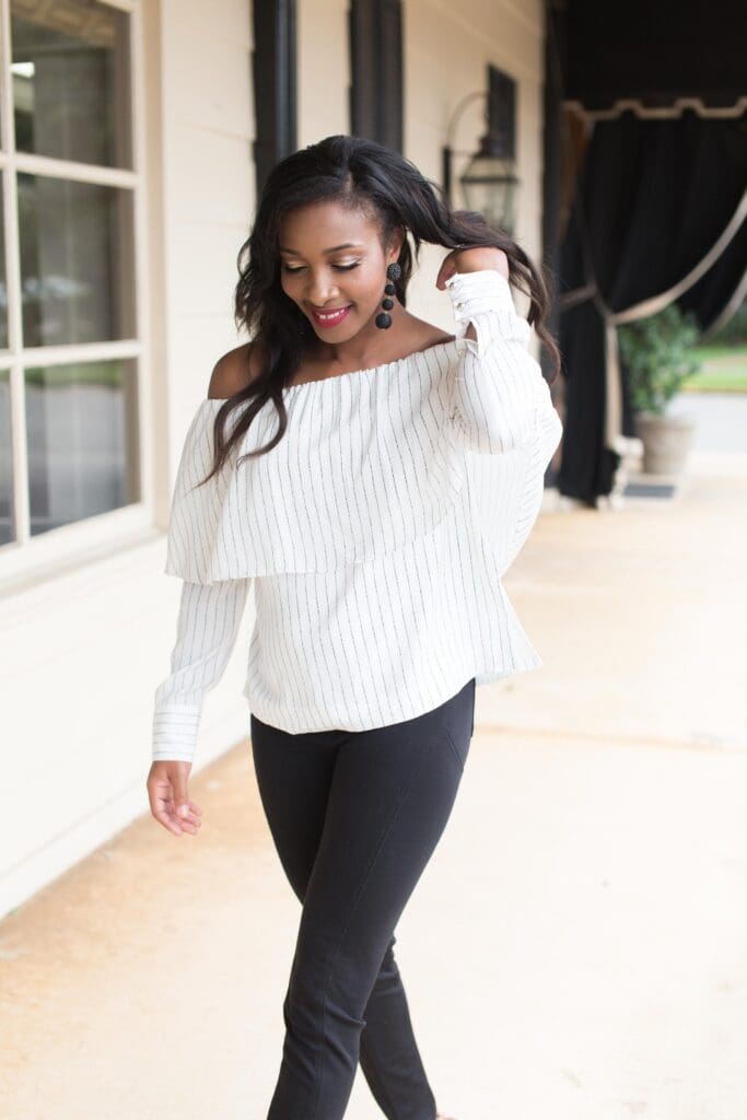 A woman in white shirt and black pants