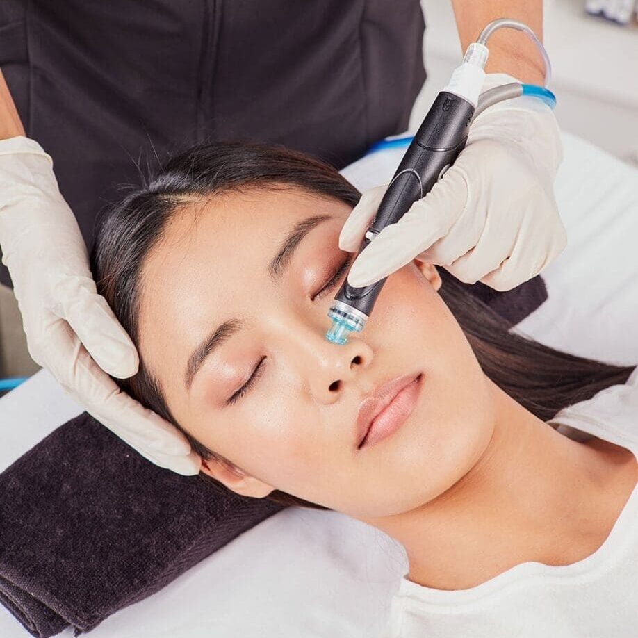 A woman getting her face waxed at the spa