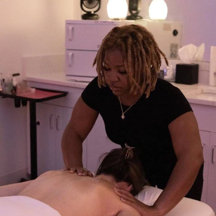 A woman is giving a massage to another person.