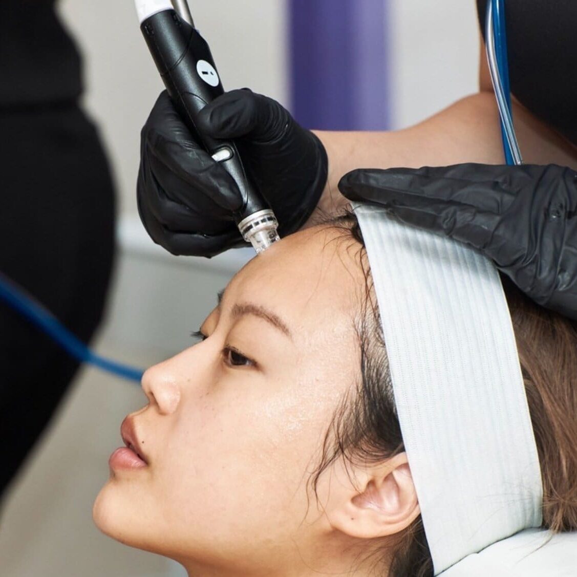 A woman getting her hair cut by an esthetician.